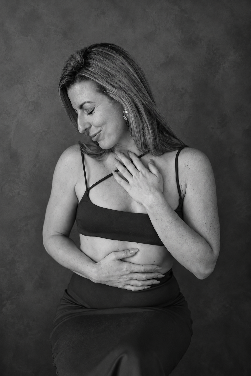 Mary Catherine with her hands resting on her heart and belly